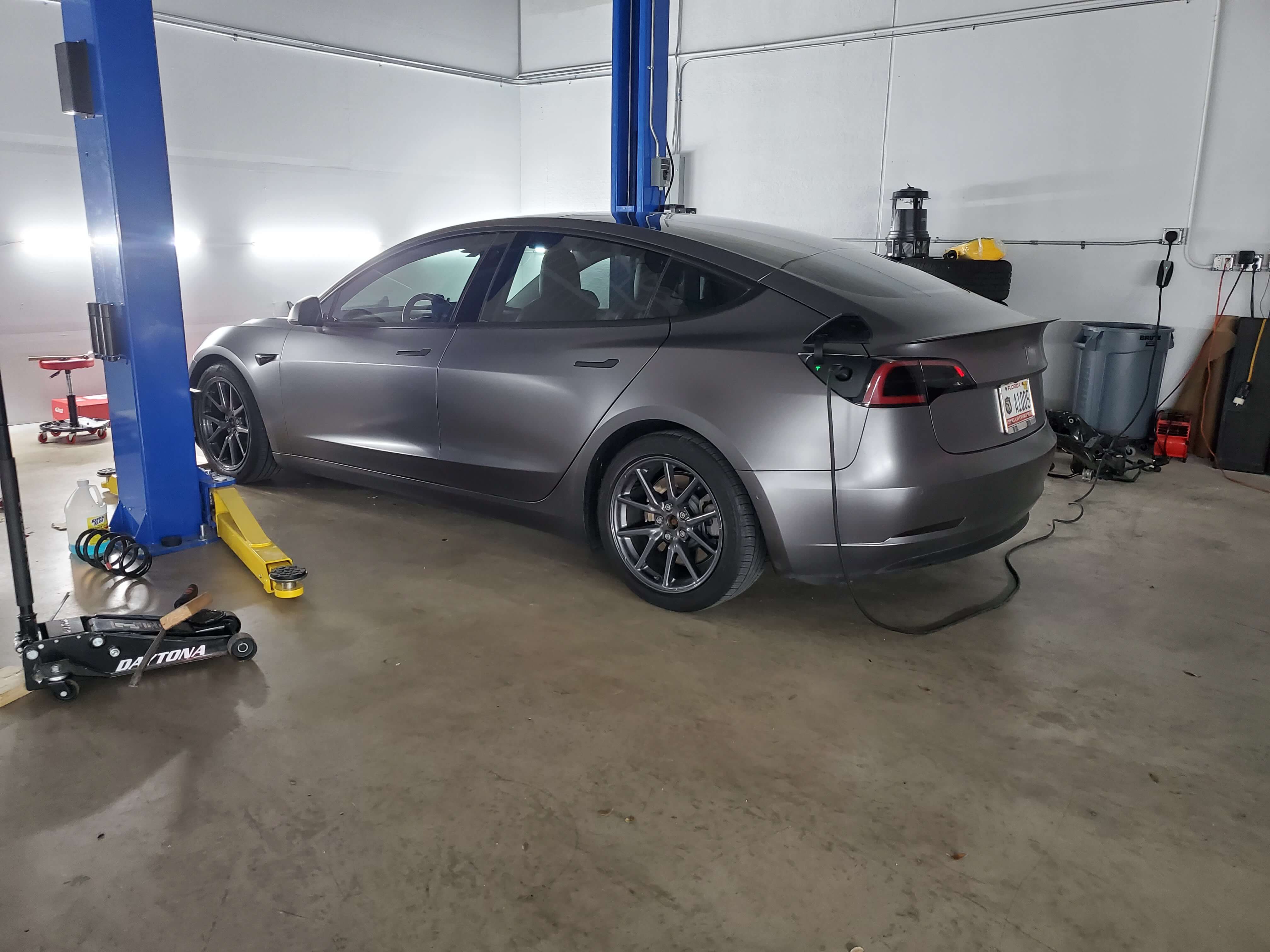Electric vehicle charging inside an Electrified Garage service facility.