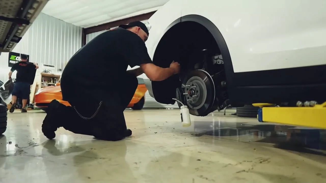 Electrified Garage technician performing wheel and brake service.